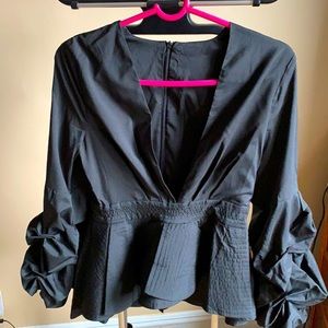 Spectacular Black peplum blouse deep V neck size S